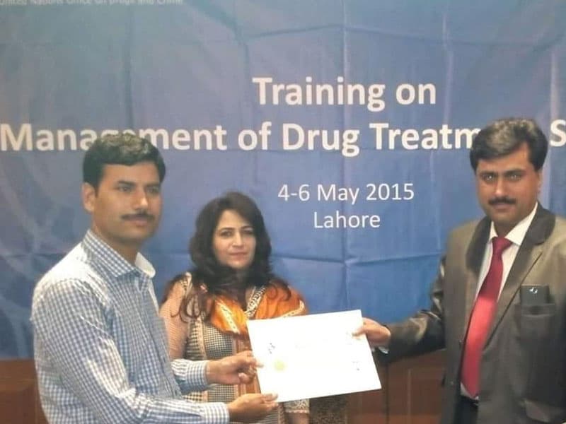 Participants receiving a certificate at a drug-treatment training workshop